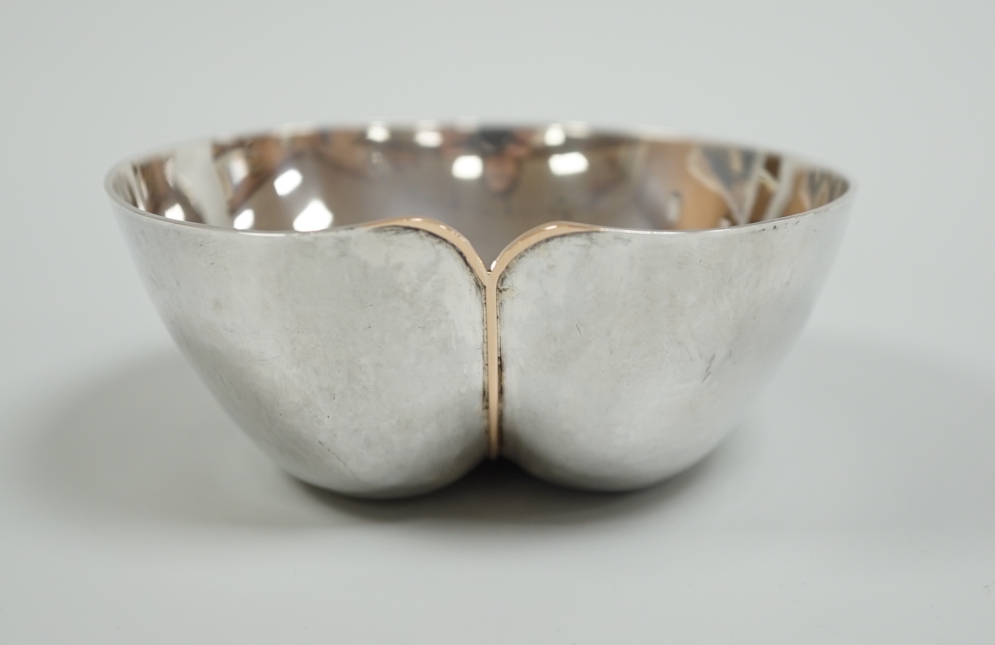 A modern silver dimpled bowl, maker CJW, London, 1982, width 10cm, 116 grams.